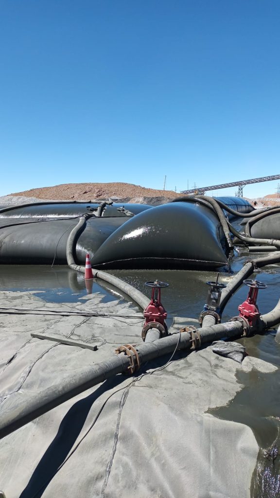 Geotubos utilizados en una operación industrial para la contención, deshidratación y gestión eficiente de sedimentos y relaves.